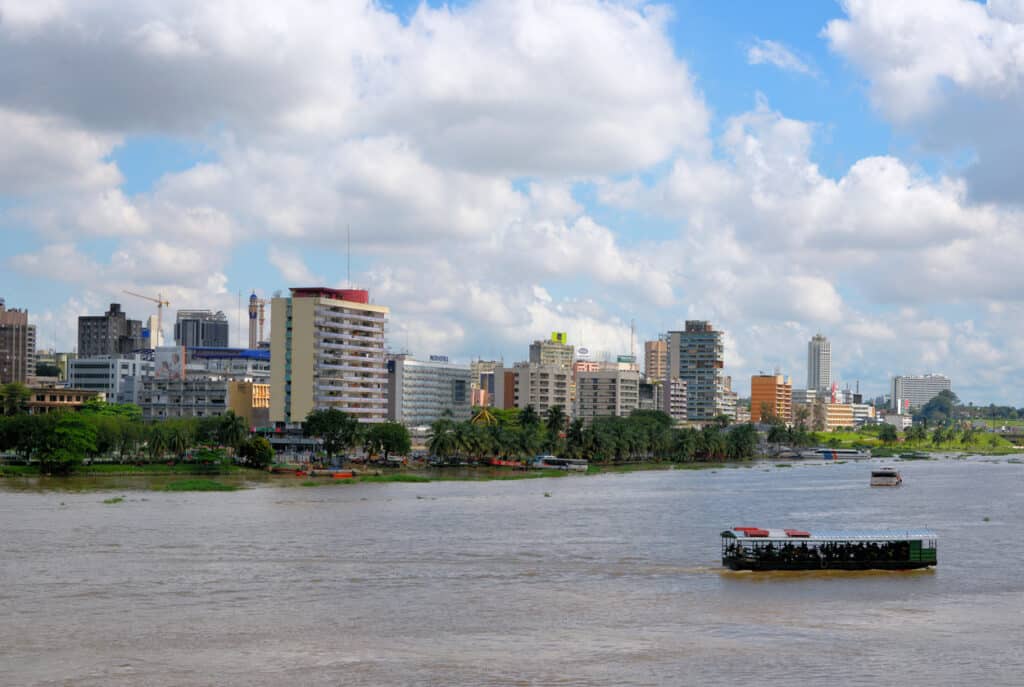 Des gratte-ciel modernes se reflétant dans les eaux de la lagune Ébrié en bordure d'Abidjan en Côte d'Ivoire.