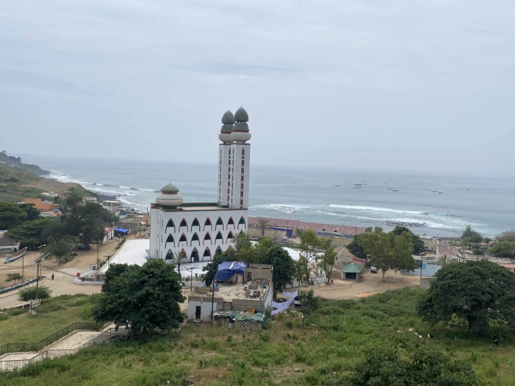Vue de la Place de l'Indépendance à Dakar avec ses jardins, ses fontaines et les immeubles modernes environnants.